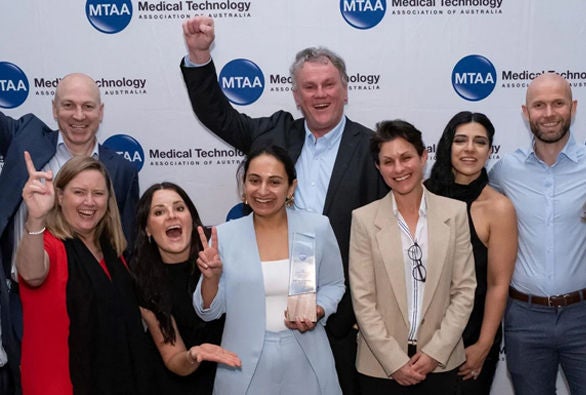 Award ceremony group celebrating medical technology.