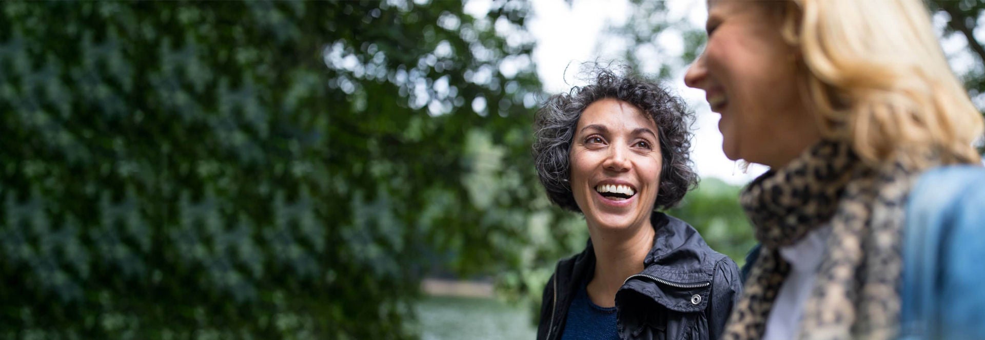Younger Asian American woman smiling confidently while doing morning walk.