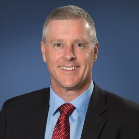Professional headshot of Troy Burke, Managing Director of Boston Scientific Australia and New Zealand, wearing a suit and smiling confidently.