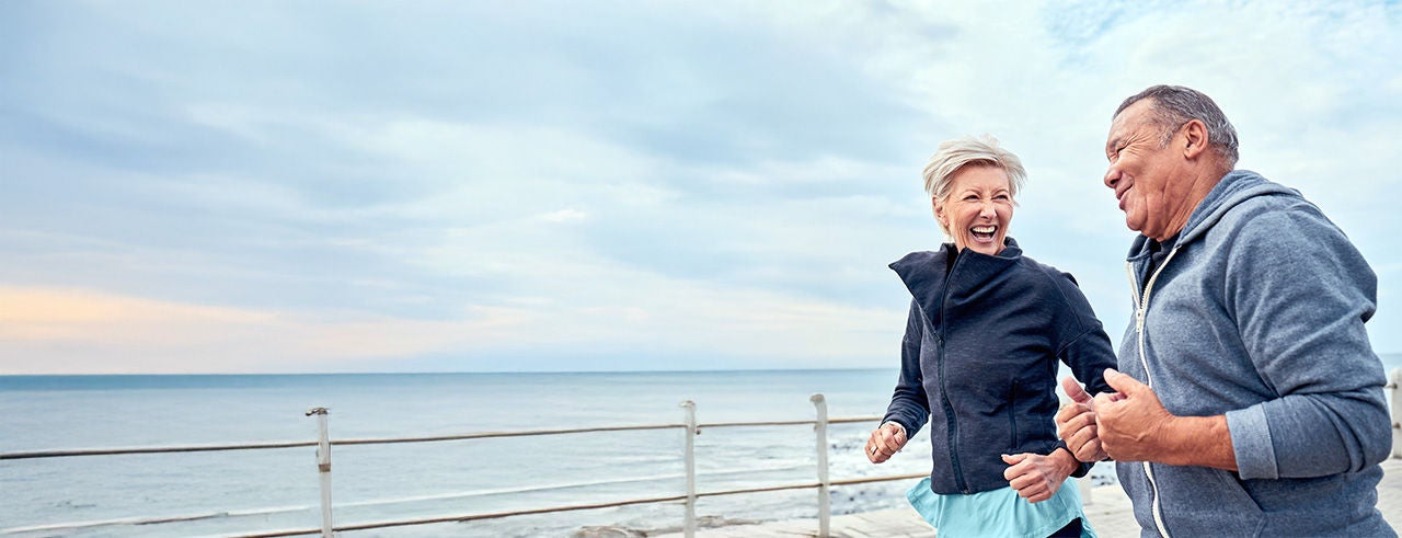 couple jogging near beach area