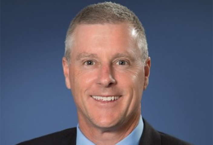 Professional headshot of Troy Burke, Managing Director of Boston Scientific Australia and New Zealand, wearing a suit and smiling confidently.