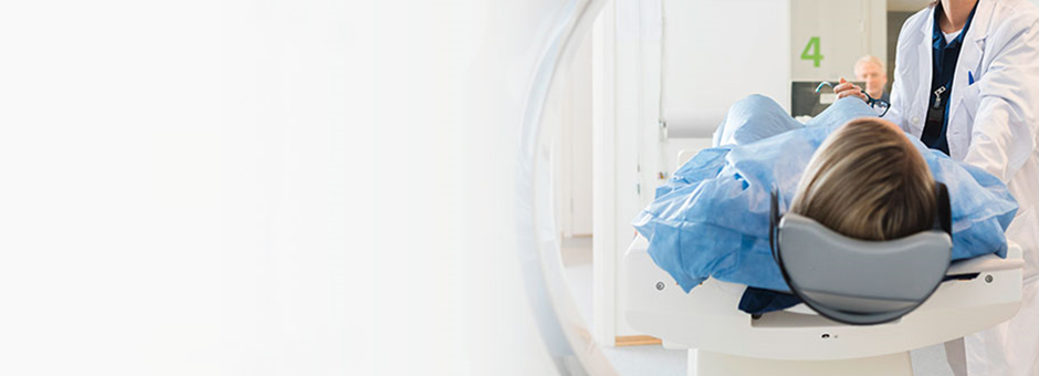 Female old patient lying on MRI bed and discussing with doctor.