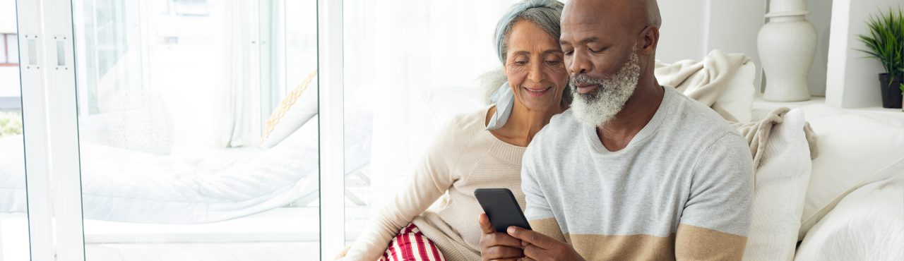 man and woman viewing a smartphone together